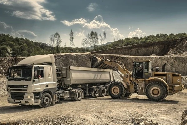 clearing rocks from land using a dump truck